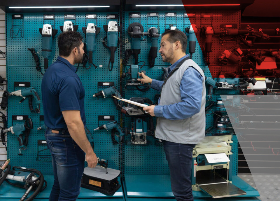 Latin American customer shopping for tools at a hardwarestore and talking to a salesman - small business concepts
